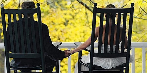 Bride & Groom Holding Hands on Porch - Eagle Mountain House - Jackson, NH - Photo Credit Jay Philbrick