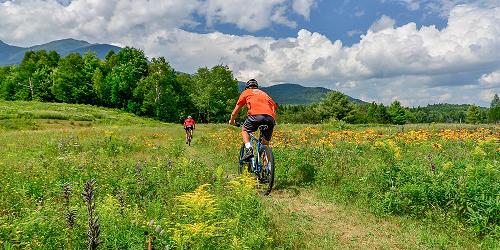 Mountain Biking through Fields - Androscoggin Valley Chamber - Berlin, NH